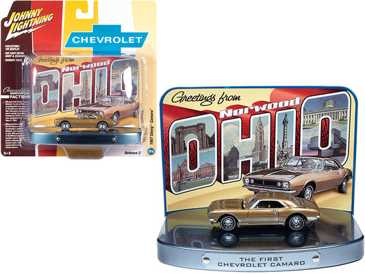 1967 chevrolet camaro gold with gold interior with collectible tin display \the first chevrolet camaro\" \"greetings from norwood - birth place of the camaro\" 1/64 diecast model car
